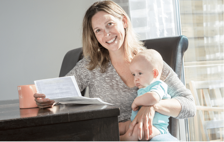 Woman with baby looking at a bill