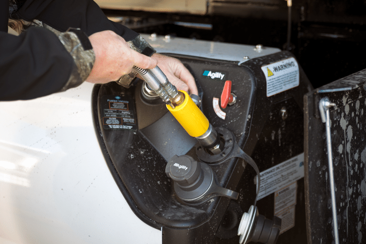 A man pumping natural gas in truck