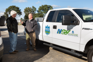 Two men talking near NGV vehicle