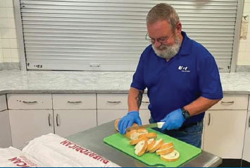 UGI employee cutting bread for a volunteer event